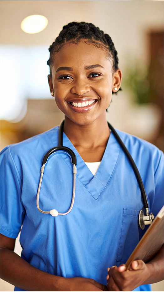 Smiling healthcare professional in blue scrubs with stethoscope.